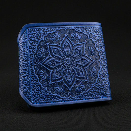Blue embossed wallet with intricate design on a black background