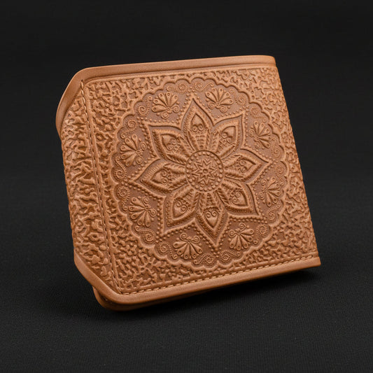 Brown leather wallet with intricate floral embossing on a white background