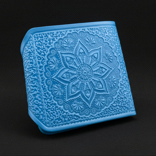 Blue leather wallet with intricate floral design on a black background