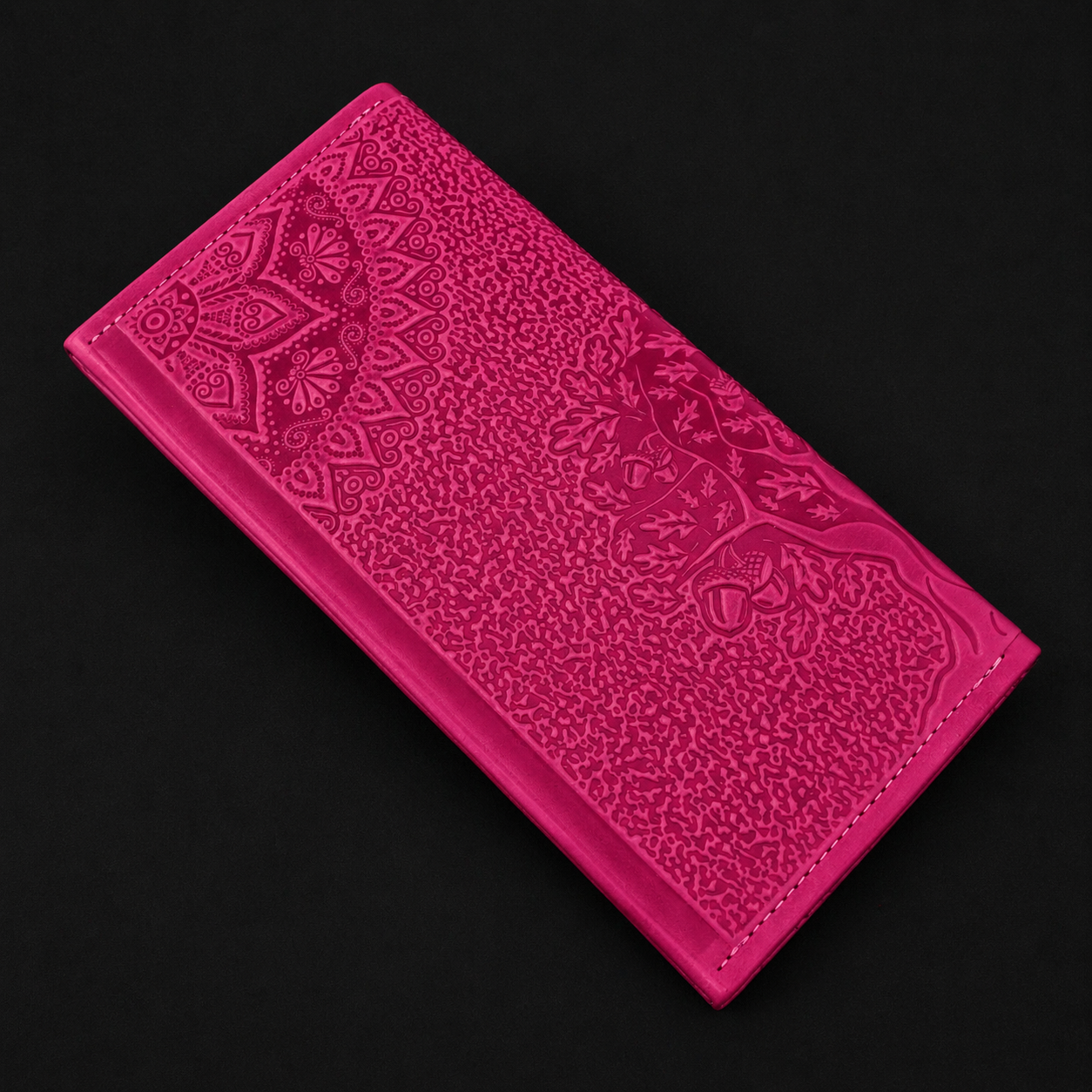 Pink embossed wallet on a black background