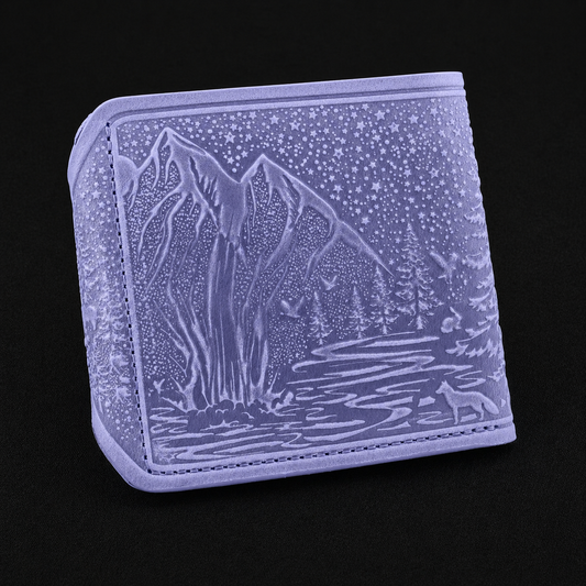 Lavender wallet with engraved mountain and wolf design on a black background