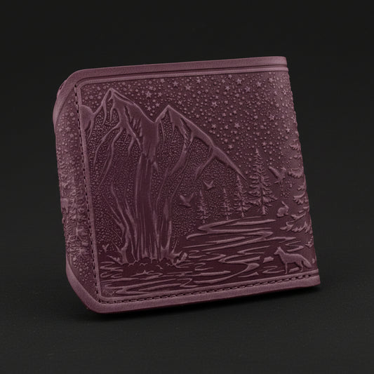 Purple embossed wallet with nature design on a black background
