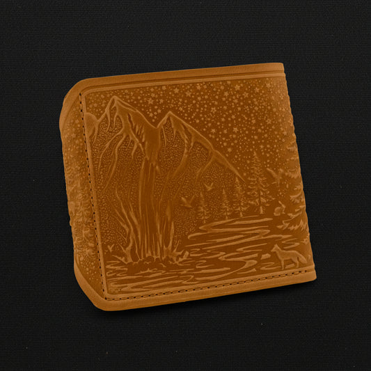 Brown leather wallet with mountain design on a black background
