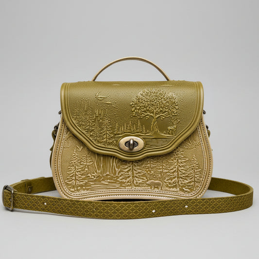 Cognac-ivory textured handbag with a scenic design on a stone surface with a garden background