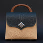 Handbag with intricate designs on a dark background