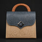 Handbag with embossed design and wooden handle on a black background