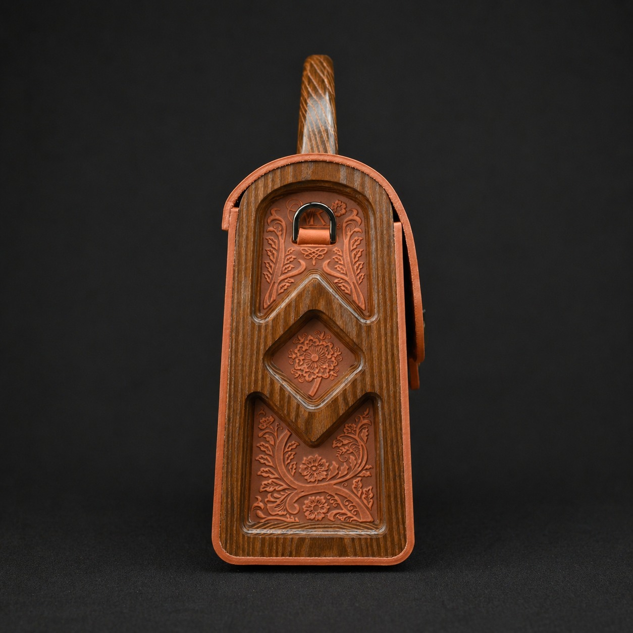 Wooden butter mold with intricate carvings on a black background