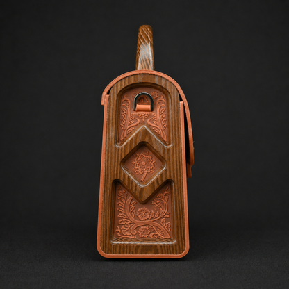 Wooden butter mold with intricate carvings on a black background