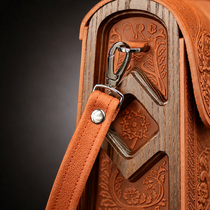 Decorative wooden bag with leather strap and metal clip on a dark background