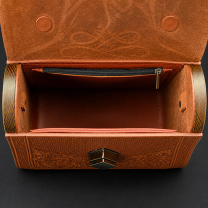 Brown leather purse with intricate patterns on a dark background