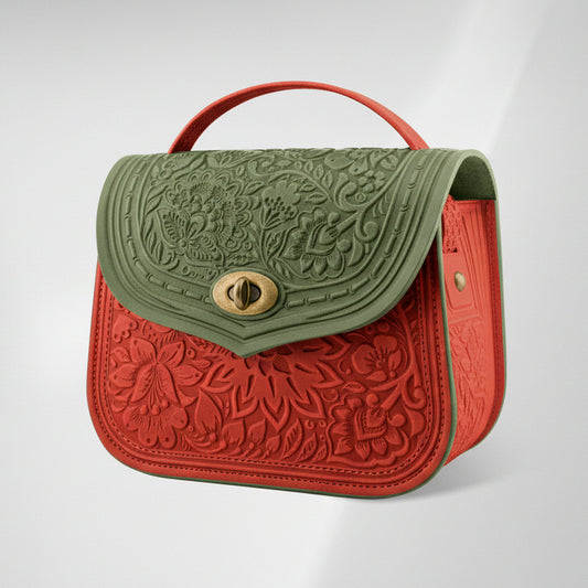 Two-tone embossed handbag with green top section and red bottom section on a light gray background