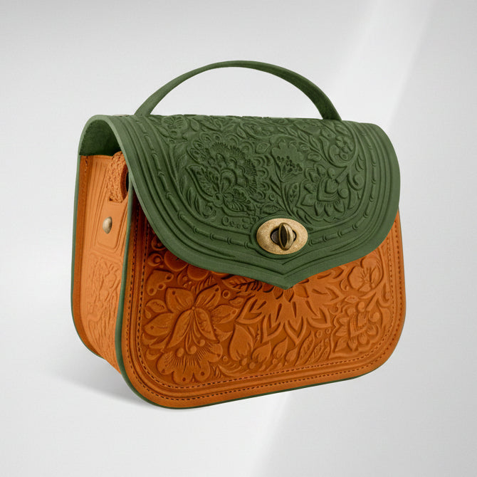 Two-tone handbag with green top section and brown bottom section on a light gray background