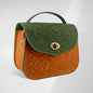 Two-tone handbag with green top section and brown bottom section on a light gray background