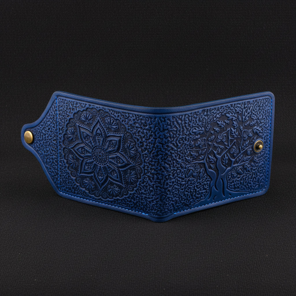 Blue leather wallet with intricate patterns on a black background