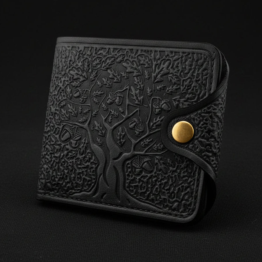 Black embossed wallet with a gold button on a light gray background