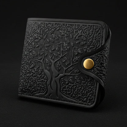 Black embossed wallet with a gold button on a light gray background
