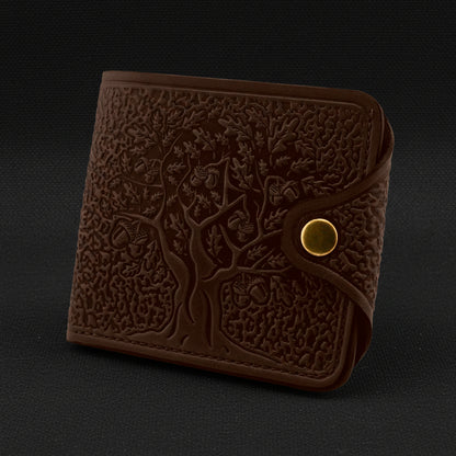 Brown leather wallet with embossed design on a black background