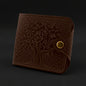 Brown leather wallet with embossed design on a black background