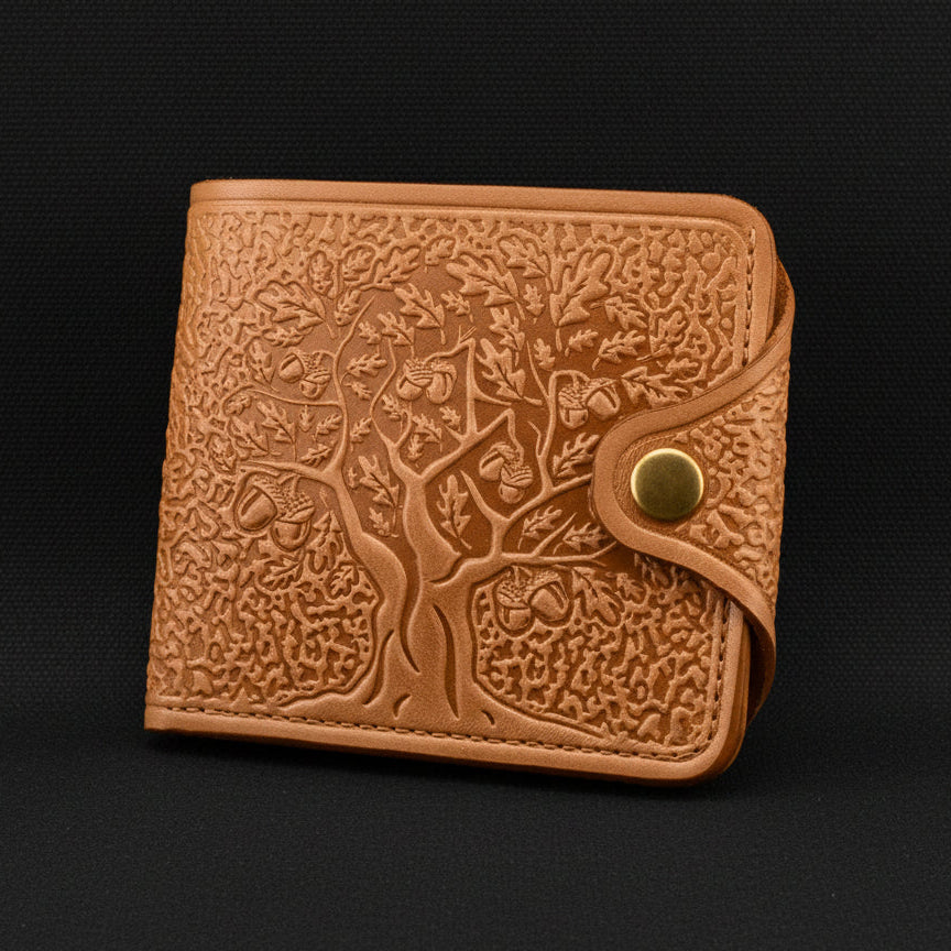 Brown leather wallet with embossed design on a white background