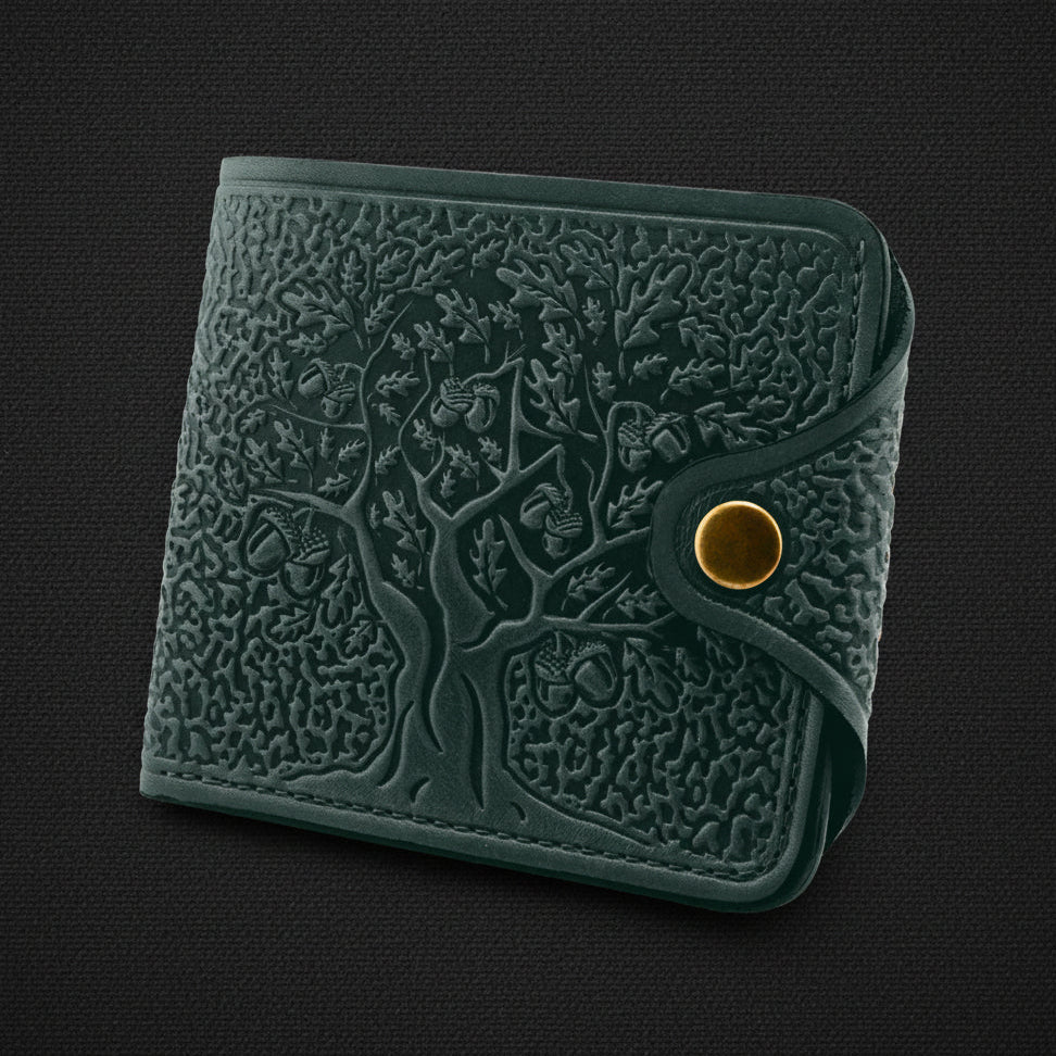 Green textured wallet with a gold button on a black background