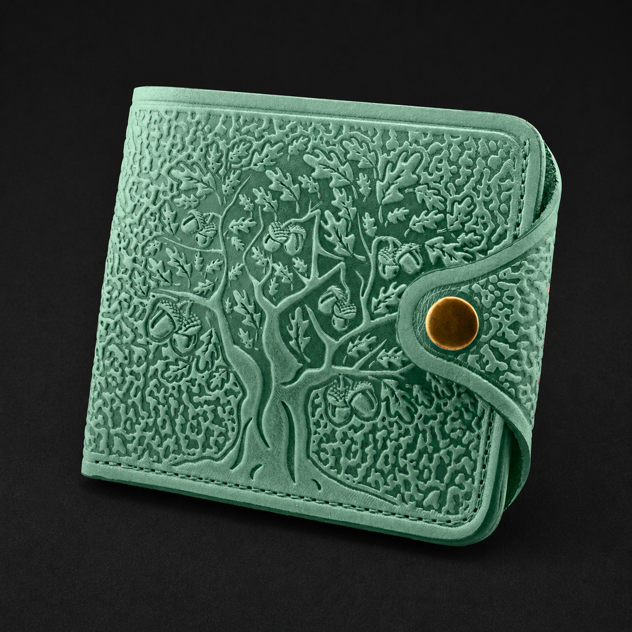 Green textured wallet with tree design on a black background