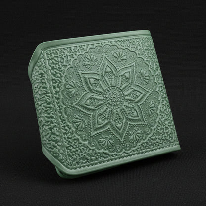 Green textured wallet with floral design on a white background