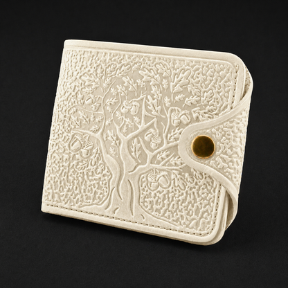 Ivory embossed wallet with tree design on a black background