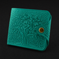 Teal textured wallet with a gold button on a black background