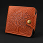 Brown leather wallet with embossed design on a black background