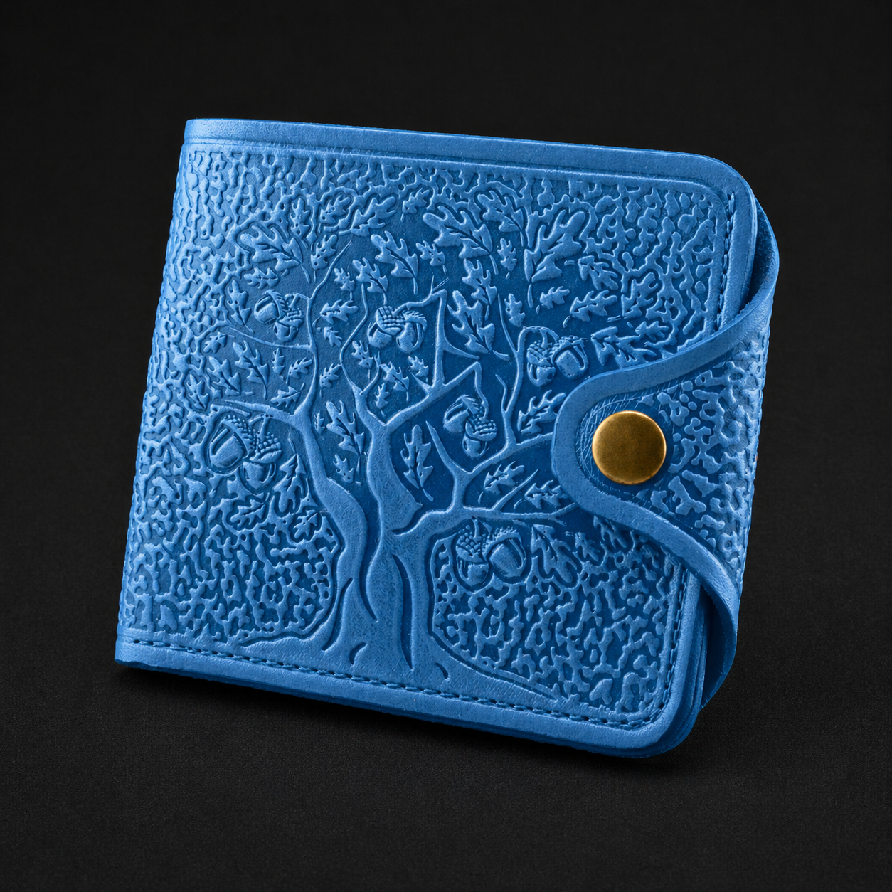Blue embossed wallet with a gold button on a black background