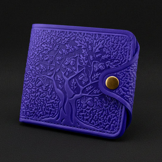 Blue embossed wallet with a gold button on a black background
