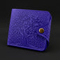 Blue embossed wallet with a gold button on a black background