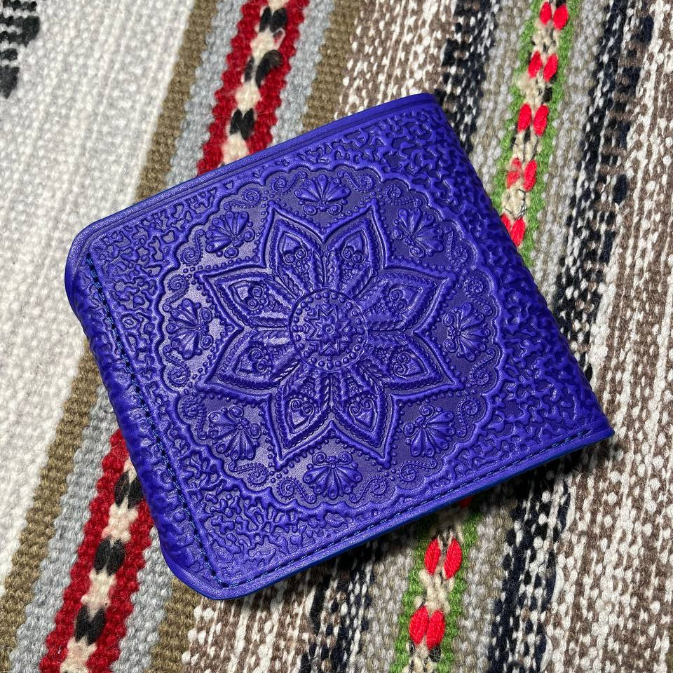 Blue embroidered fabric on a patterned fabric background