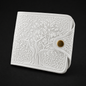 White embossed wallet with a gold button on a black background