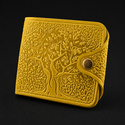 Yellow embossed wallet with tree design on a black background