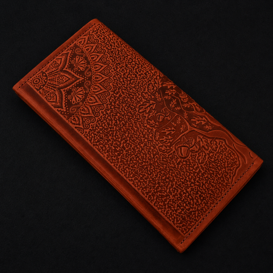 Brown leather wallet with intricate patterns on a black background
