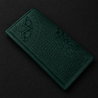 Dark green embossed leather wallet on a black background