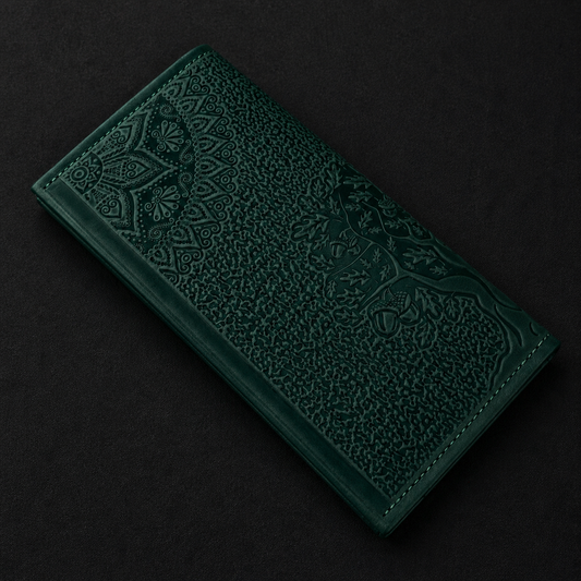 Dark green embossed leather wallet on a black background