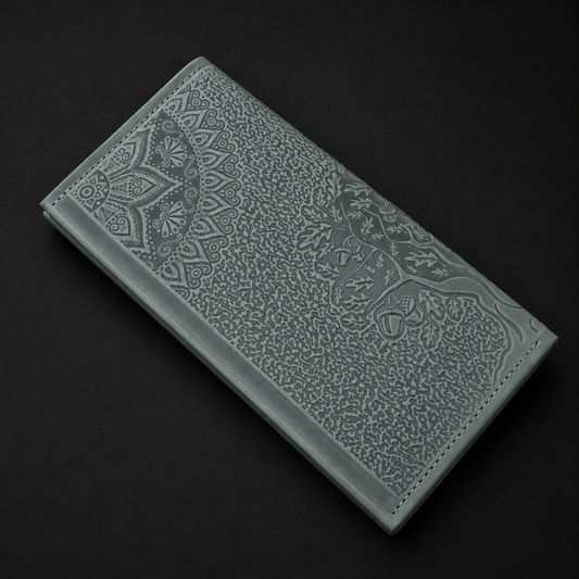 Green leather wallet with intricate patterns on a black background