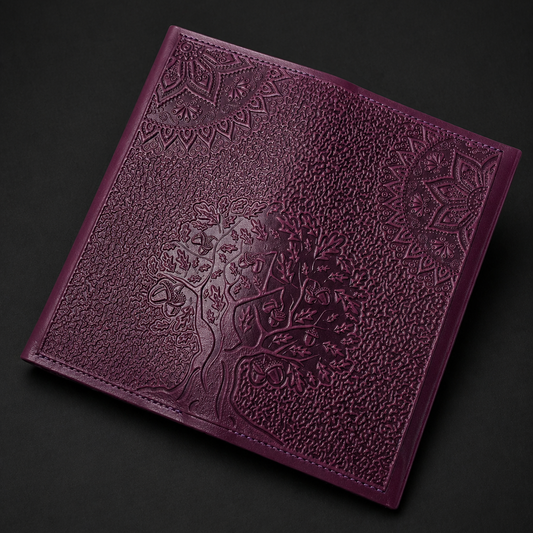 Purple leather wallet with embossed design on a dark background
