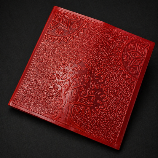 Red leather-bound book with embossed design on a black background