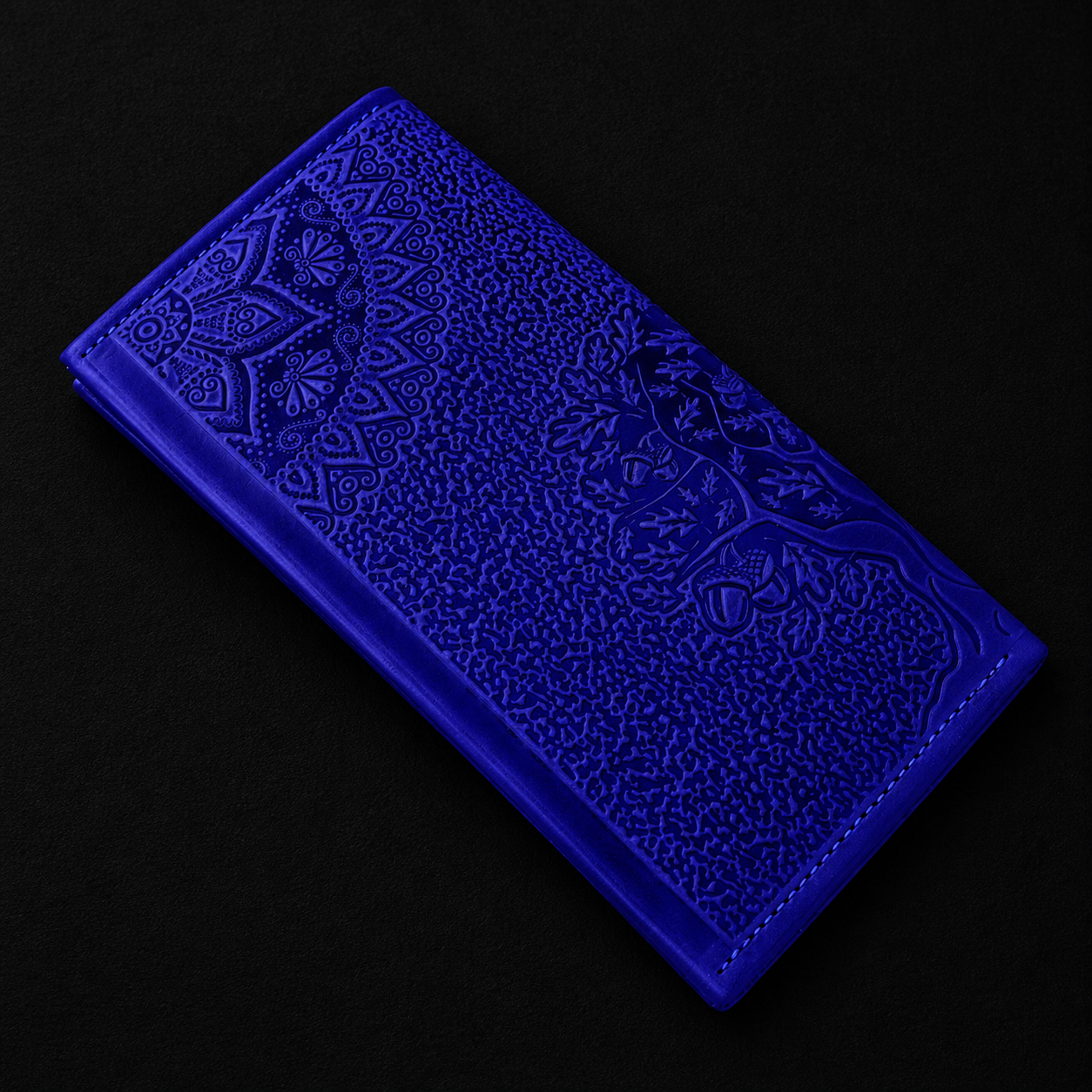 Blue embossed wallet on a black background