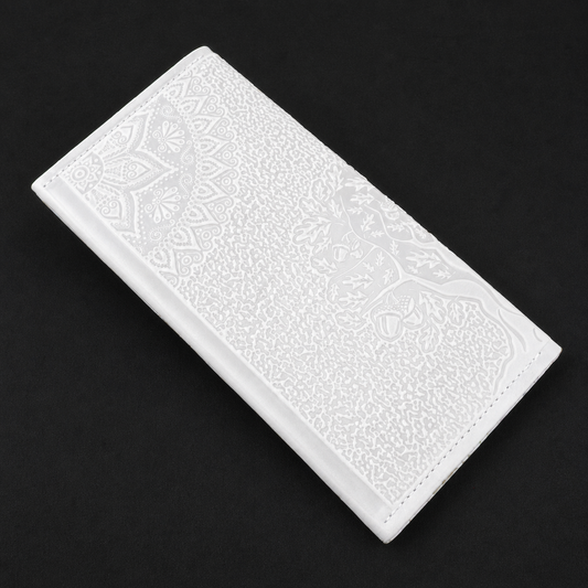 White rectangular tile with embossed pattern on a black background
