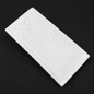 White rectangular tile with embossed pattern on a black background