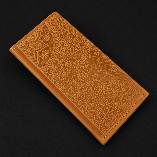 Brown leather wallet with intricate patterns on a black background