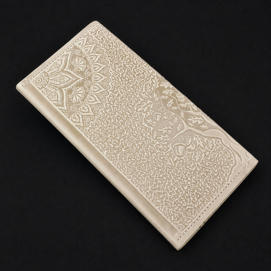 Ivory wallet with embossed patterns on a black background