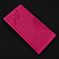 Pink embossed wallet on a black background