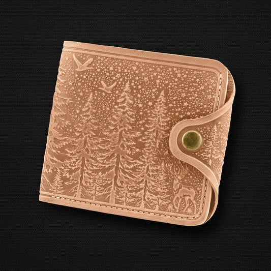 Beige leather wallet with forest design on a black background