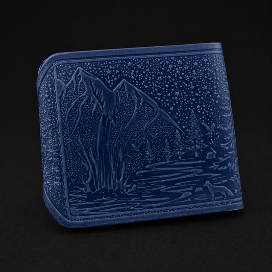 Blue embossed wallet with nature design on a black background