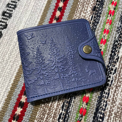 A blue leather wallet placed on a patterned fabric surface.